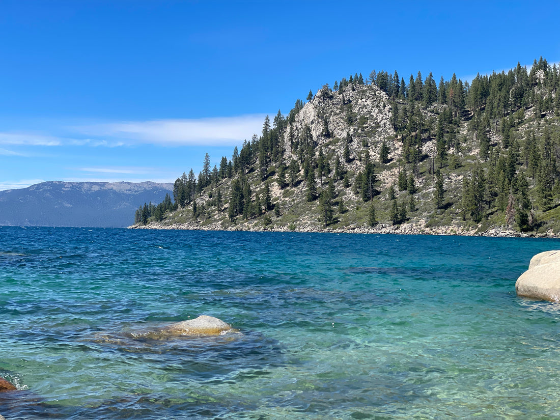 Stunning view of the western side of Lake Tahoe from the Monkey Rock Trail, showcasing the serene waters and surrounding landscape.